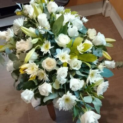 Peace and white  - A selection of lillies, rose's,spider chrysanthemum white roses make this casket spray wonderful presence on any casket 